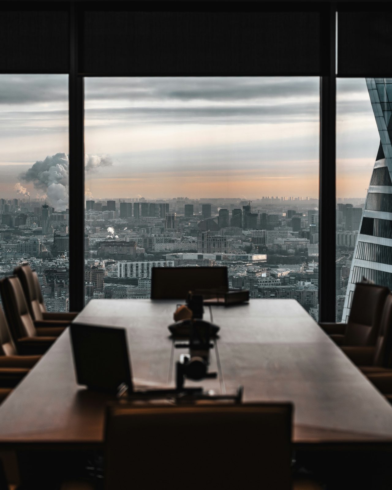 A boardroom high above the city at dusk