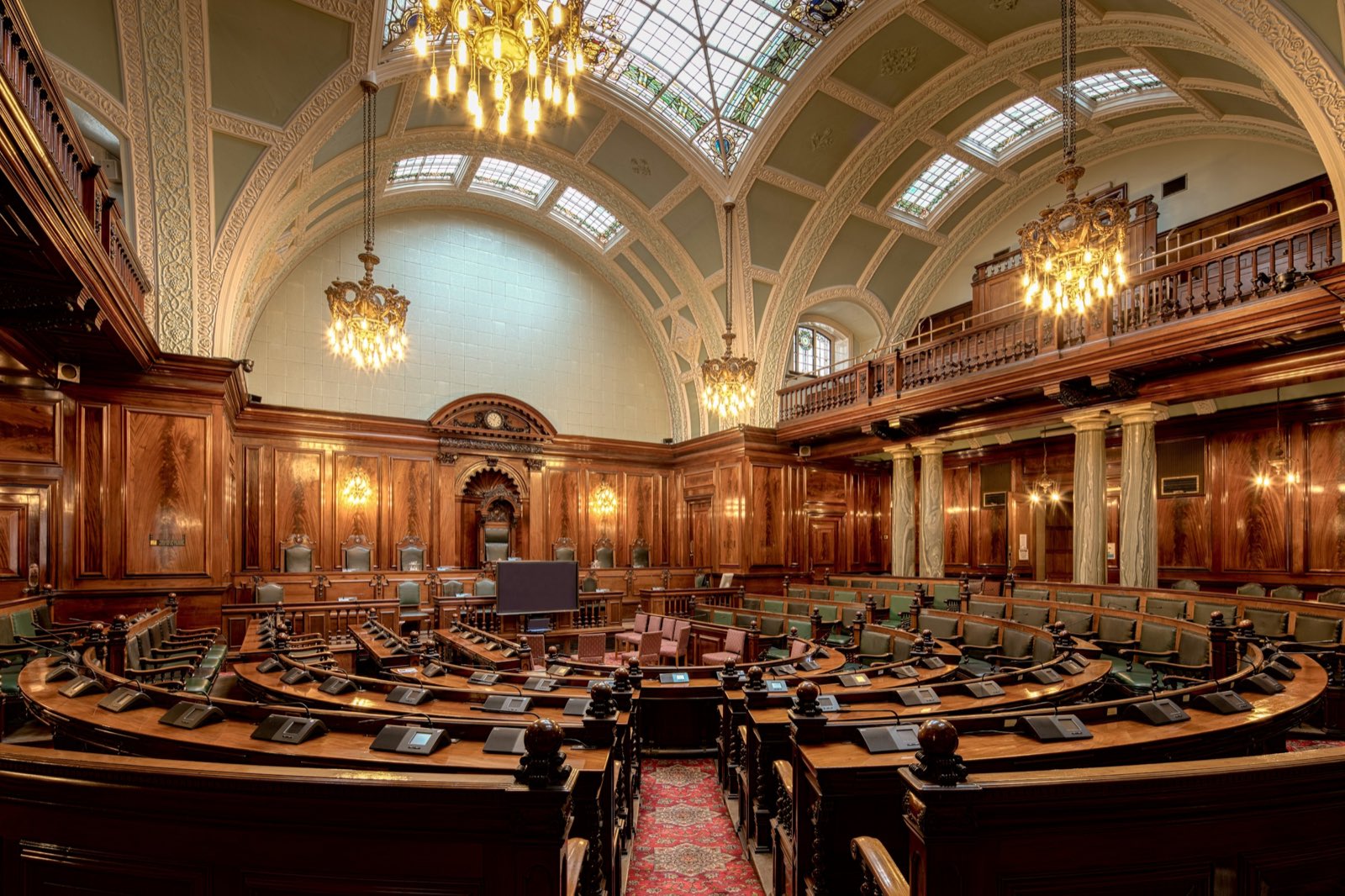 A panelled assembly chamber under a glass roof
