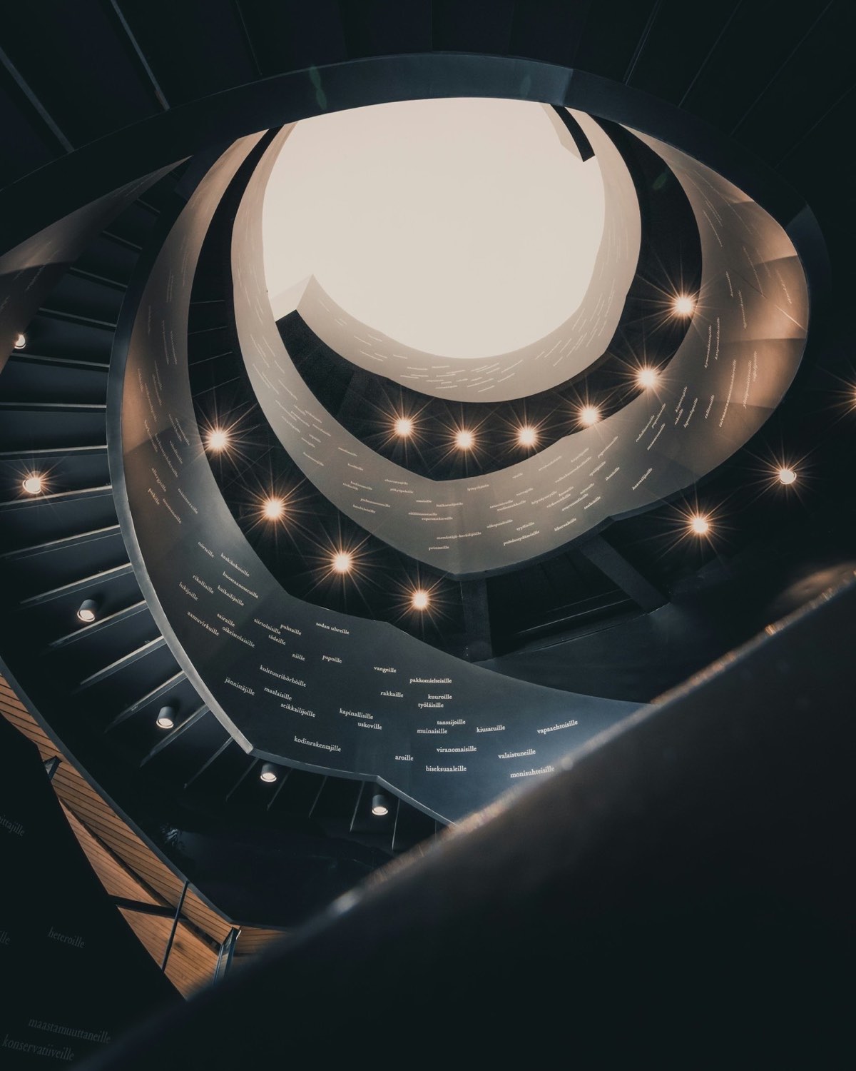 A spiral staircase in a library, seen from below