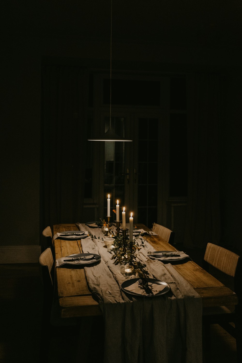 A table set for six by candlelight