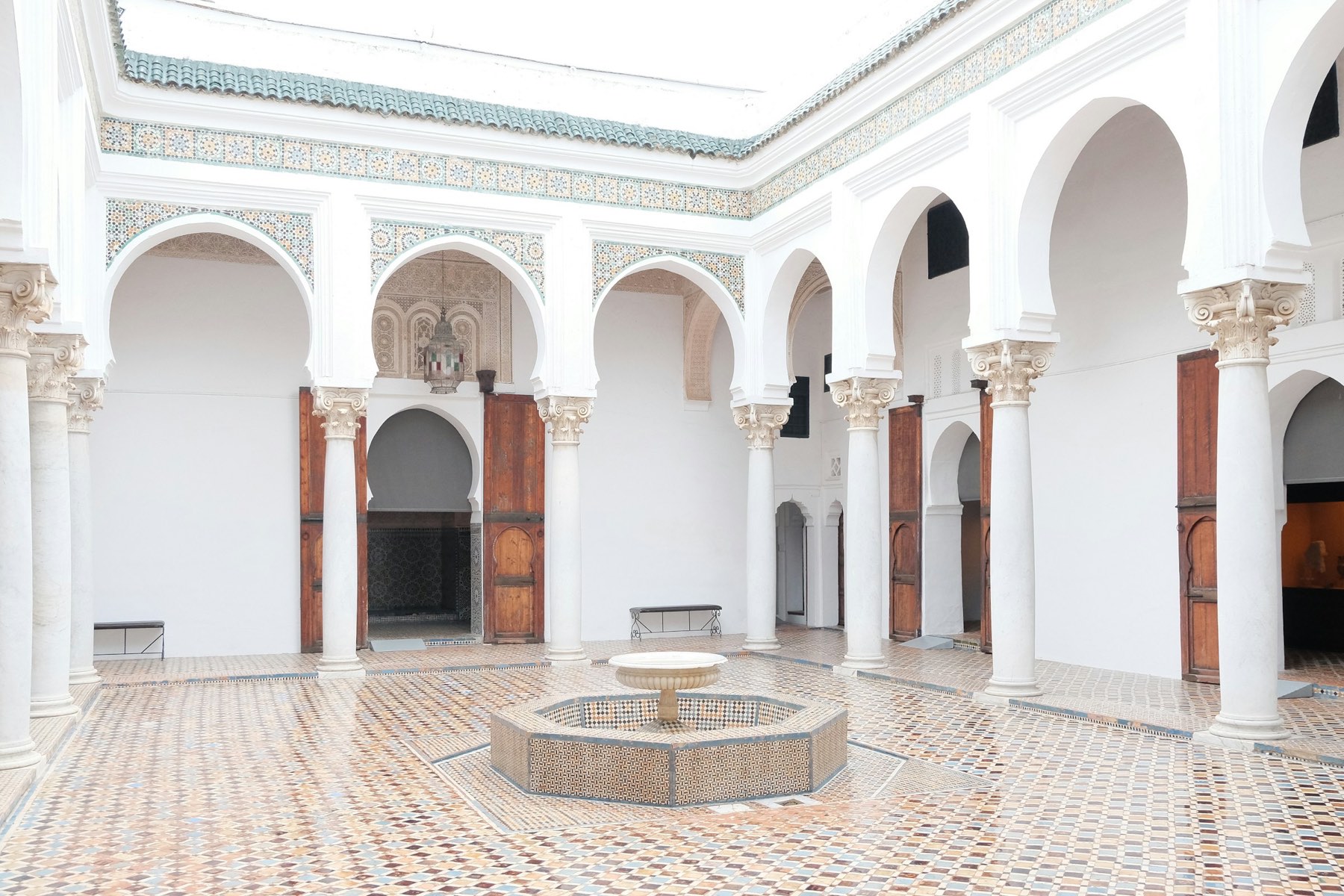 A white arcaded courtyard with a fountain